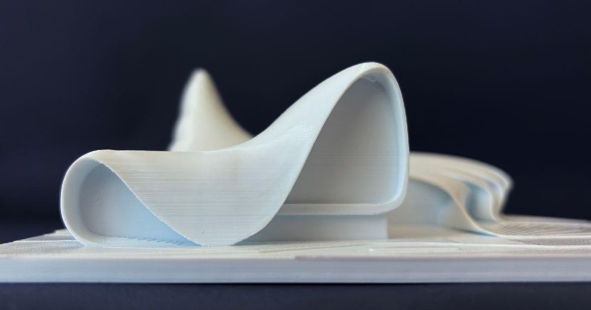 Detailed close-up showing layers and curves of Heydar Aliyev Center 3D print — graphic design by Adrian Martinez