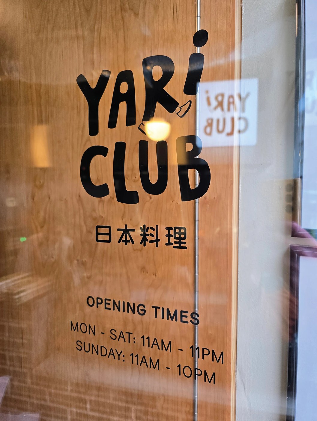 YARI CLUB restaurant brand identity concrete coasters with red logo debossing detail.