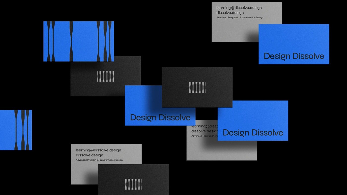 Design Dissolve brand identity business cards flat-lay in charcoal and blue — brand identity