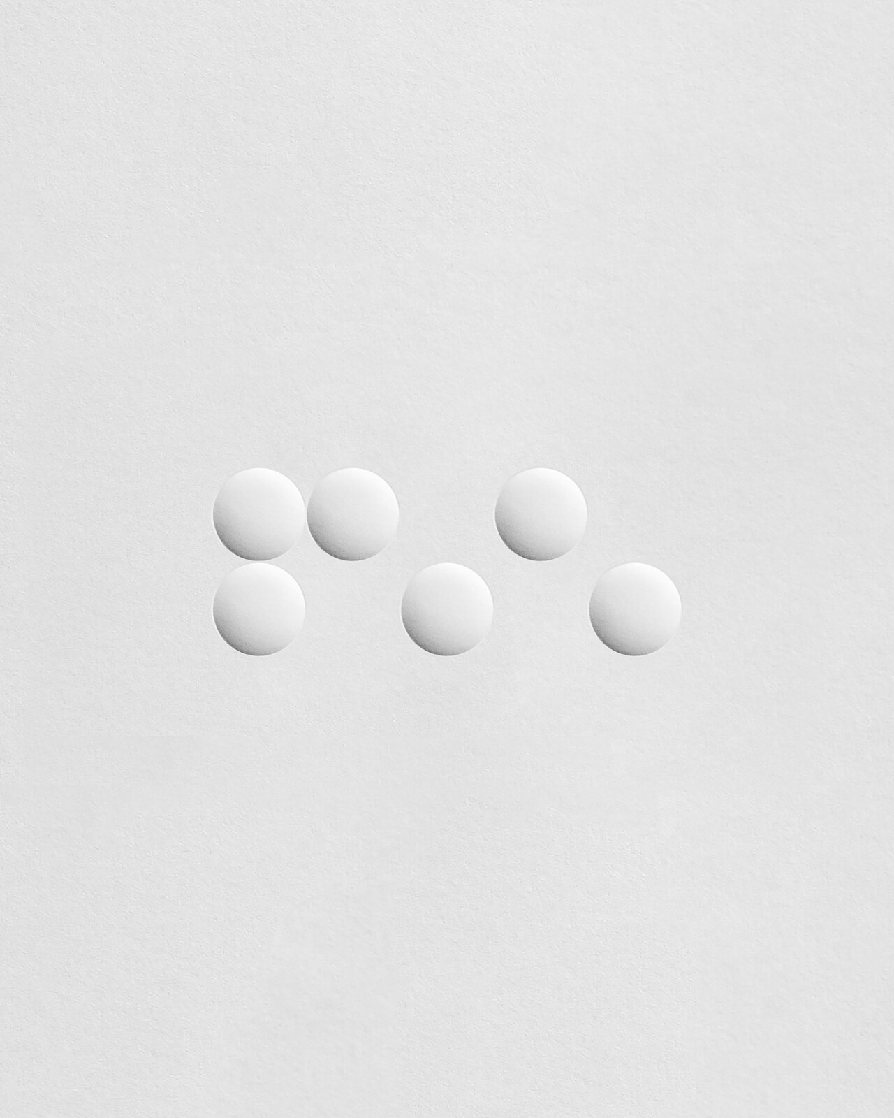 Microdot brand identity embossed stationery showing tactile design quality