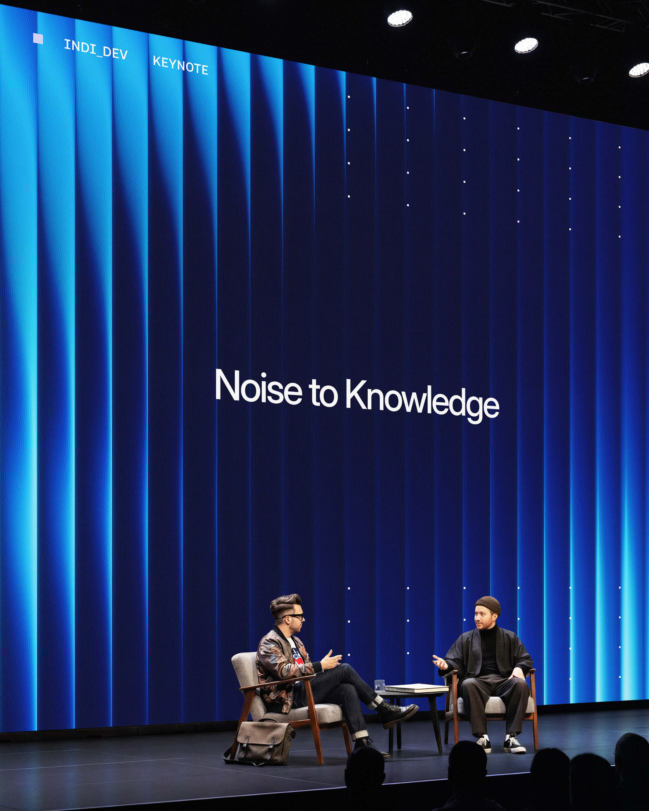 Noise to Knowledge keynote stage — Fractal Glass brand identity in live event context