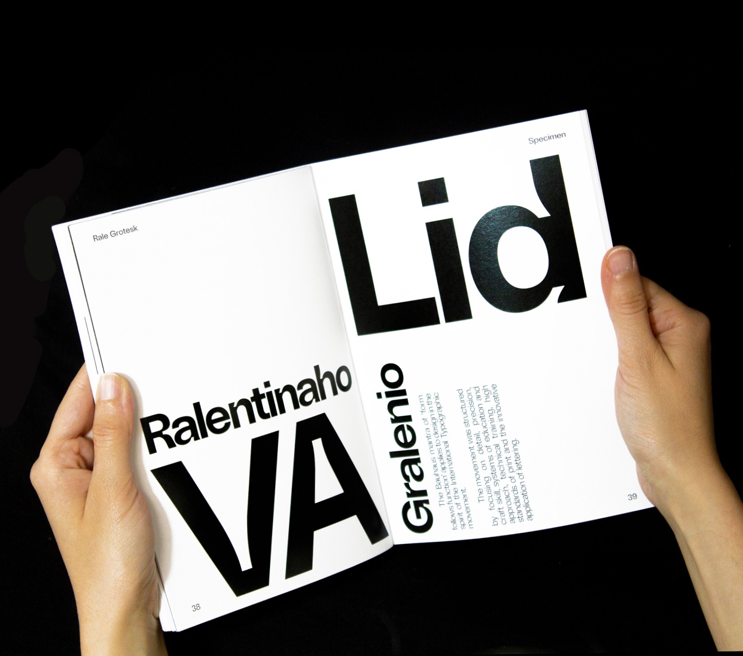 Person hold the specimens book of Rale Grotesk Family